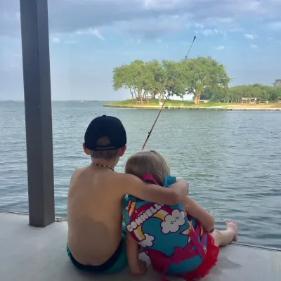 children near the water on dock